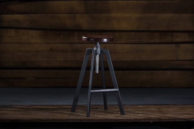 Free photo tall bar stool on a wooden background