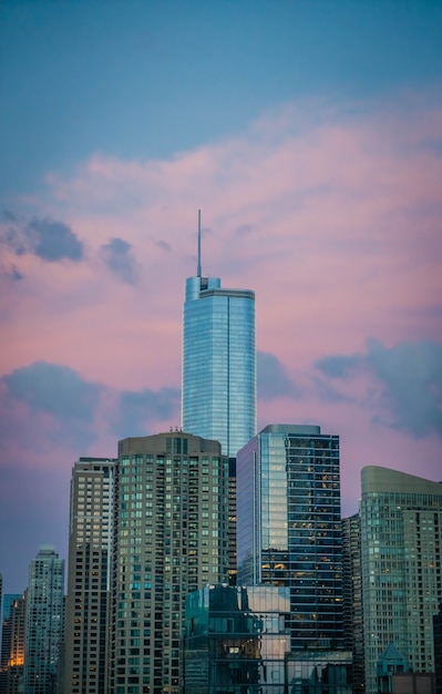 Tall business building skyscraper in Chicago, US, with beautiful pink clouds in the blue sky