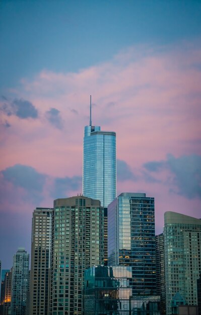 Tall business building skyscraper in Chicago, US, with beautiful pink clouds in the blue sky