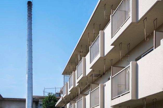 Tall chimney near building side view