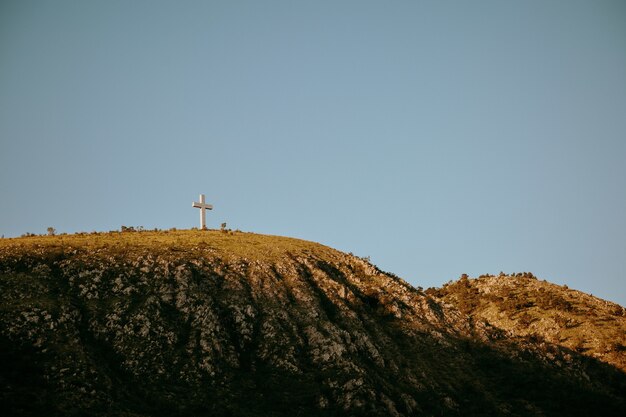 Tall cross statue on top of a hill in Mostar, Bosnia and Herzegovina