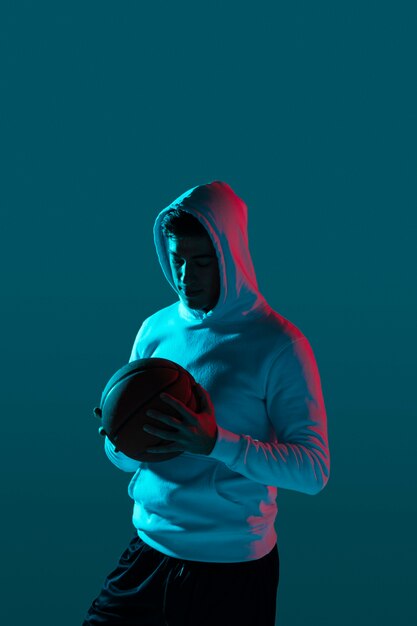 Tall man playing basketball with cool lights