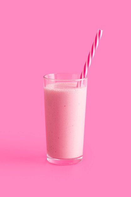 Tall pink smoothie glass with straw