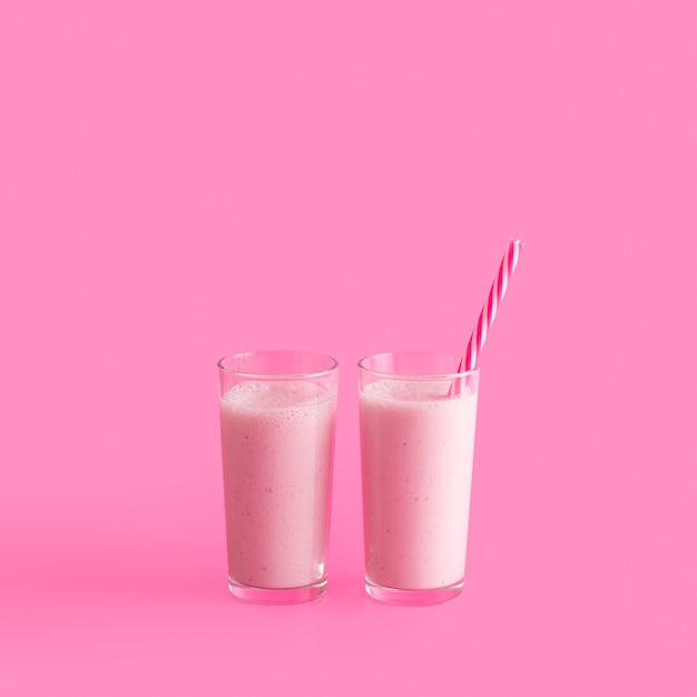 Tall pink smoothie glasses with straw