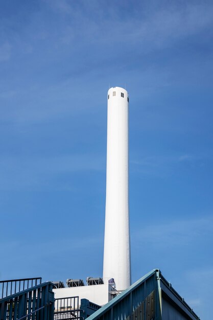Tall white chimney with blue sky