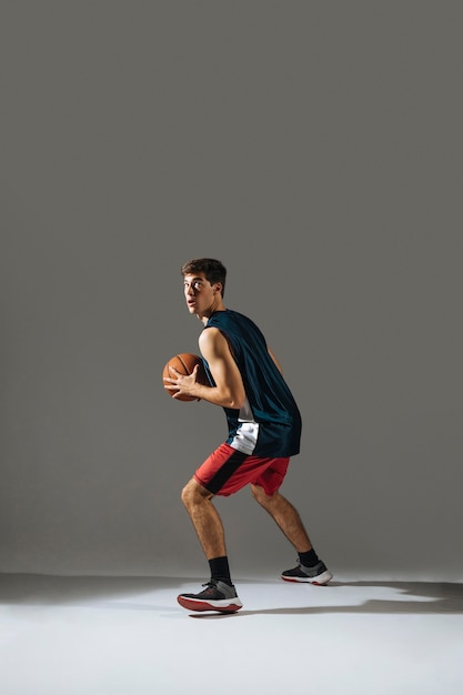 Tall young man playing basketball