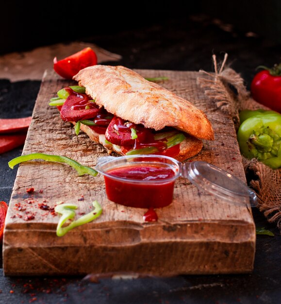 Tandir bread doner, sucuk ekmek with sausage on a wooden board