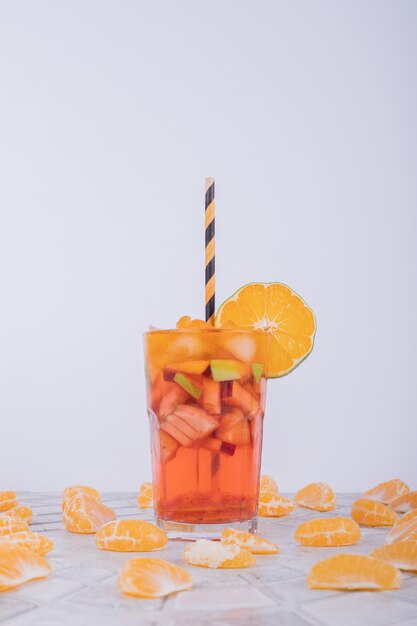 Tangerine juice on glass on white