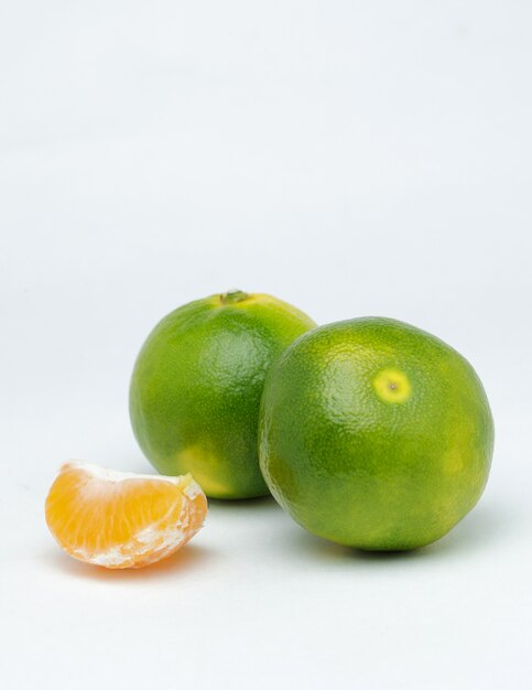 Tangerine slices on a white surface