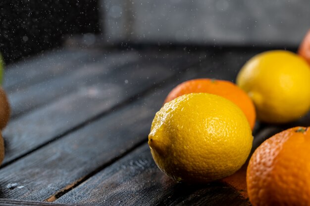 Tangerines and lemons on a wooden table