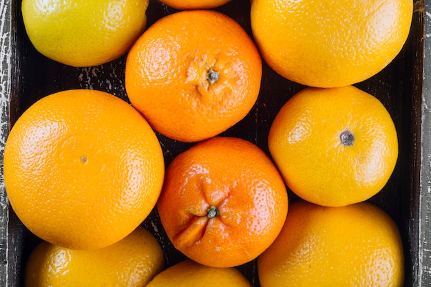 Tangerines and oranges in wooden chest