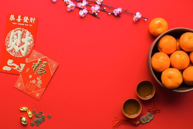 Free photo tangerines and tea cups on red