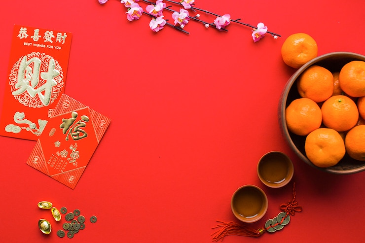 Free Photo tangerines and tea cups on red