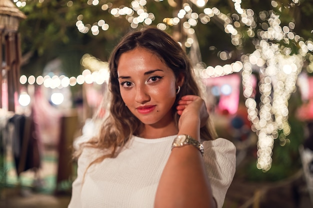 Tanned Caucasian female with fierce posing at an amusement park