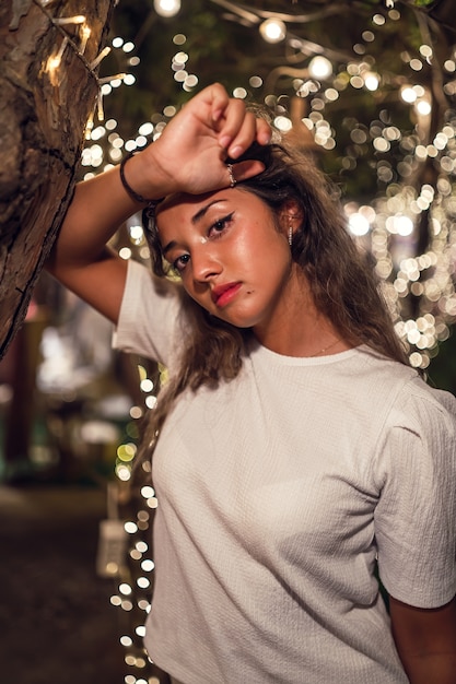 Tanned Caucasian female with fierce posing at an amusement park