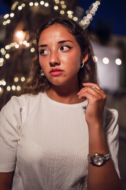 Tanned Caucasian female with fierce posing at an amusement park