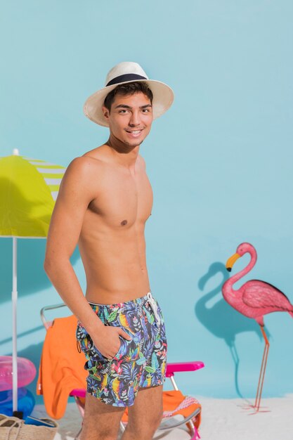 Tanned guy on standing on beach