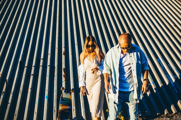 Free photo tanned young caucasian couple, modern lovestory in film grain effect and vintage style.