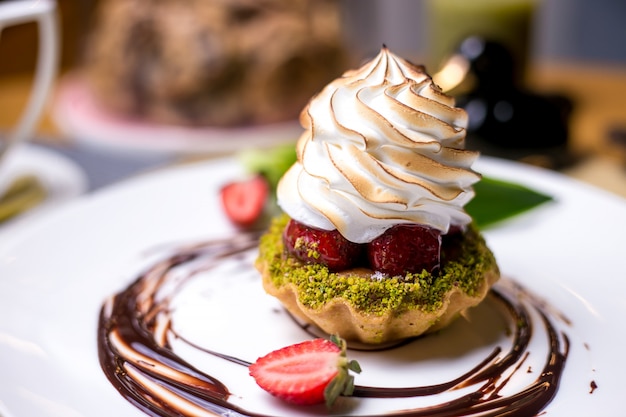 Tartlets with pistachios strawberry cream chocolate side view