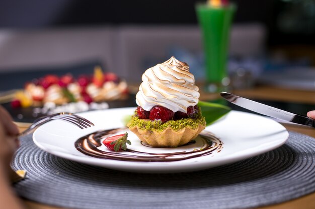 Tartlets with pistachios strawberry cream chocolate side view