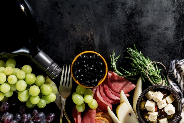 Free photo tasty appetizing italian mediterranean food ingredients flat lay on dark old black background top view copy space above