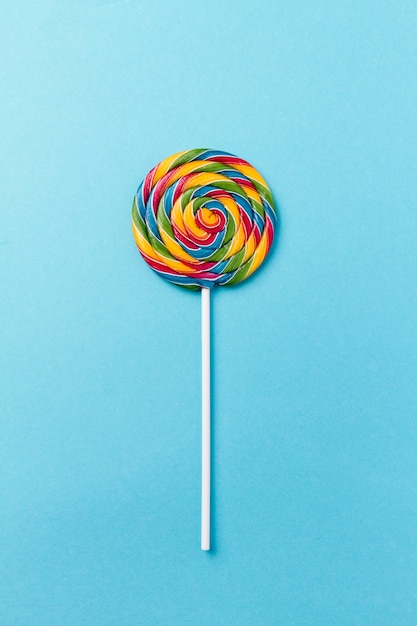 Tasty appetizing Party Accessory Sweet Swirl Candy Lollypop on Blue Background Top View