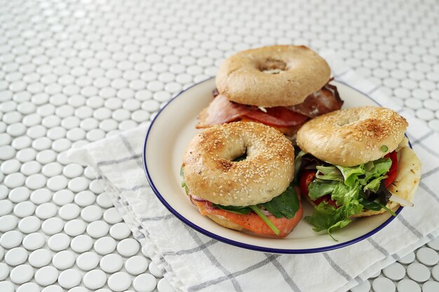 Tasty bagel sandwich with bacon