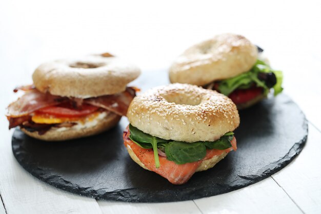 Tasty bagel sandwich with bacon