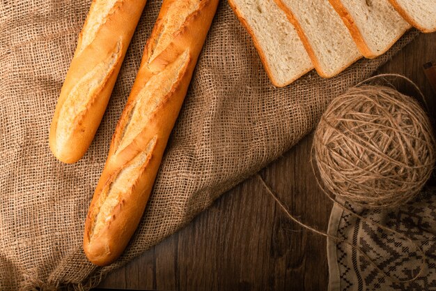 Tasty baguette with slices of white bread
