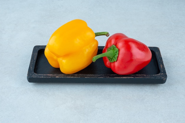 Free photo tasty bell peppers on a board, on the marble.