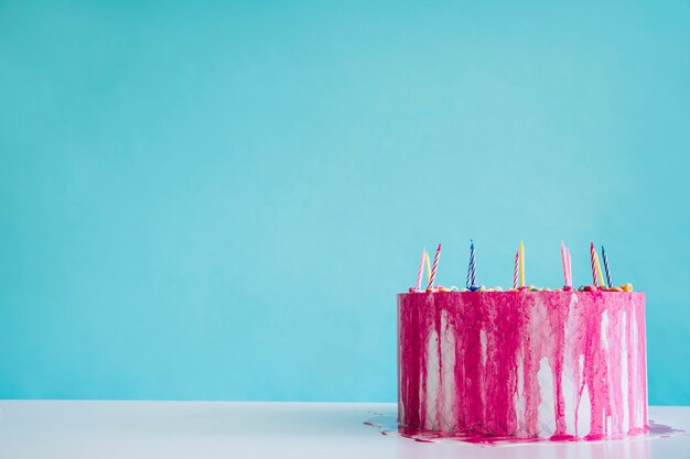 Tasty birthday cake on turquoise background