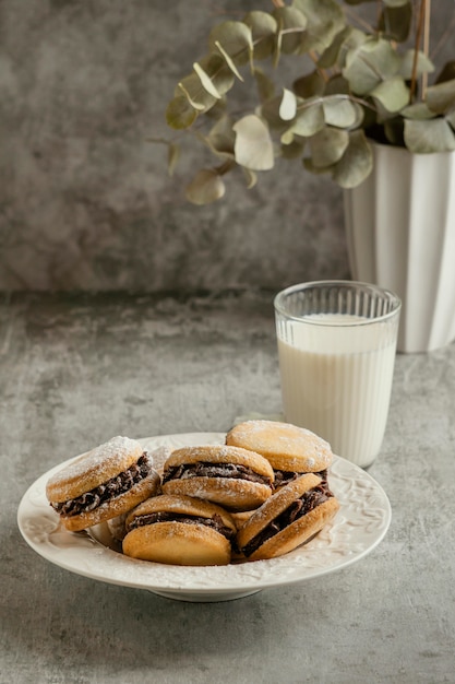 Tasty biscuits with chocolate filling and milk