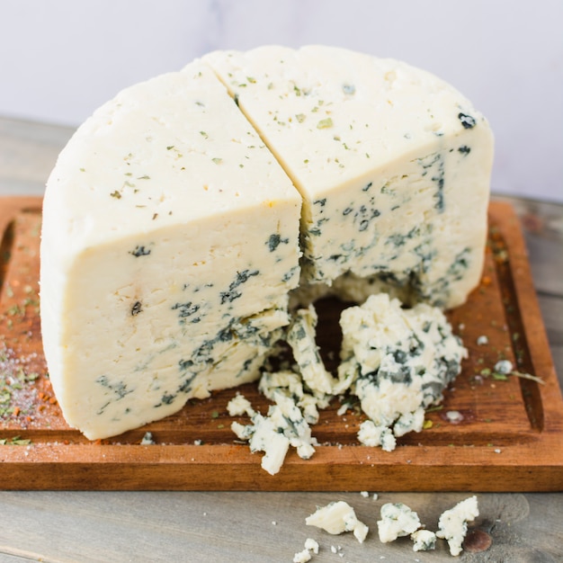 Tasty blue cheese slice on chopping board