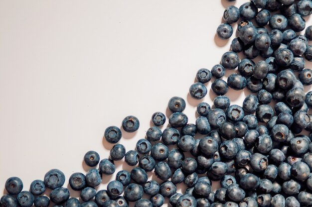 Tasty blueberries isolated on white background. Blueberries are antioxidant organic superfood. Blueberries background. Blueberry border design. Ripe and juicy fresh picked bilberries close up. Copyspace for your text