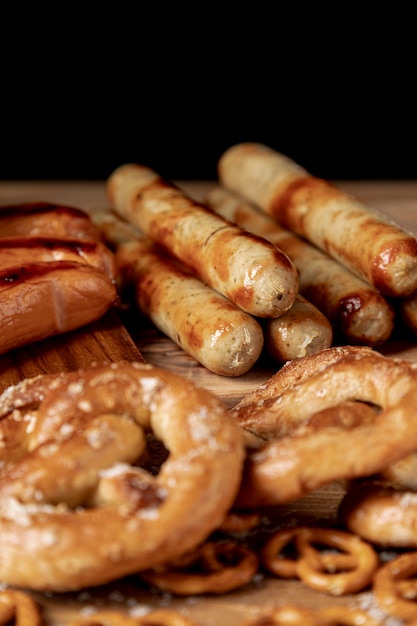 Tasty bratwurst with pretzels on a table
