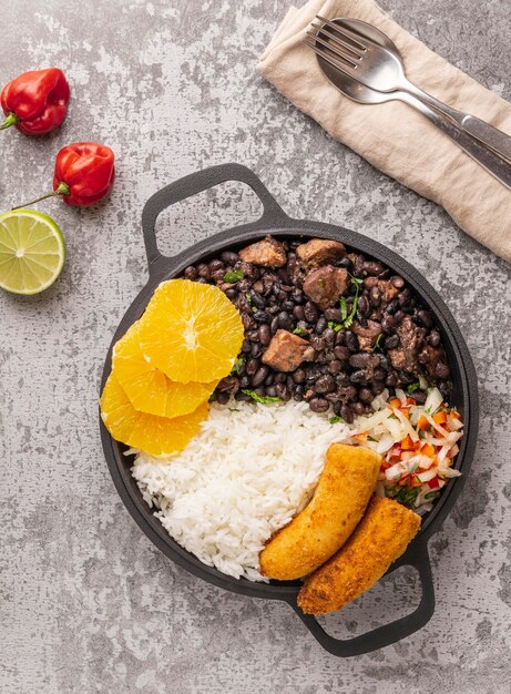 Tasty brazilian dish with orange flat lay