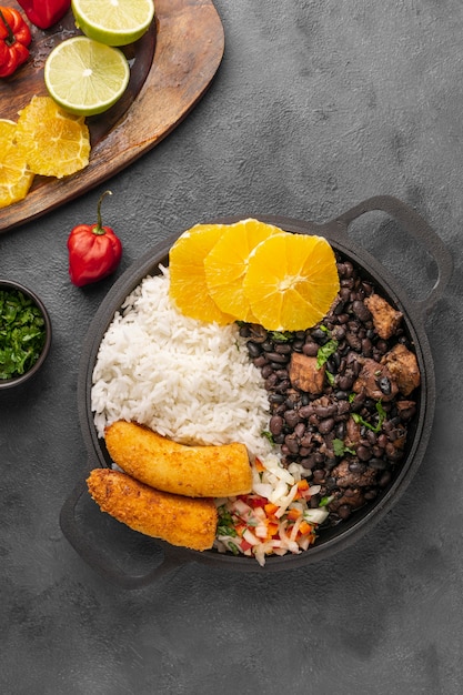 Free photo tasty brazilian dish with orange above view