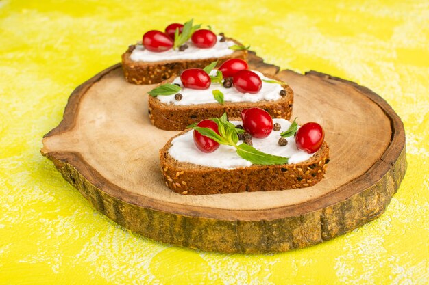 tasty bread toasts with sour cream and dogwoods on yellow