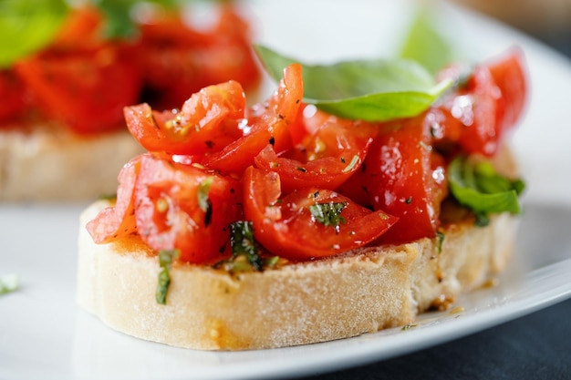 Tasty bruschetta with tomatoes and basil