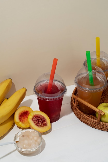 Tasty bubble tea drinks and colorful straws high angle