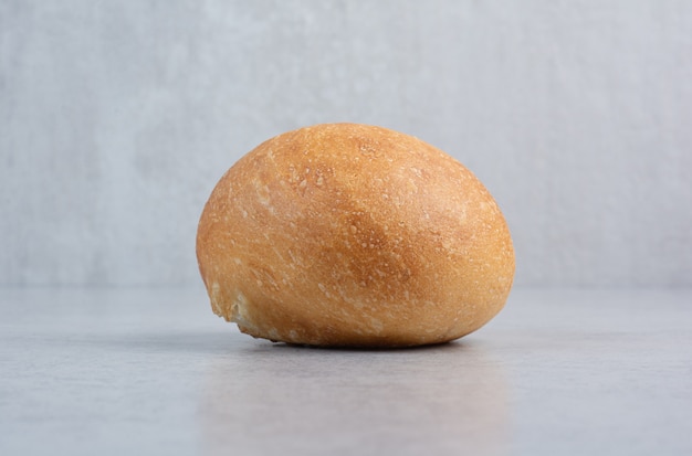 Tasty burger bun on marble background. High quality photo