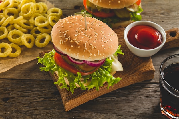 Tasty burger with lettuce, pickles and tomato