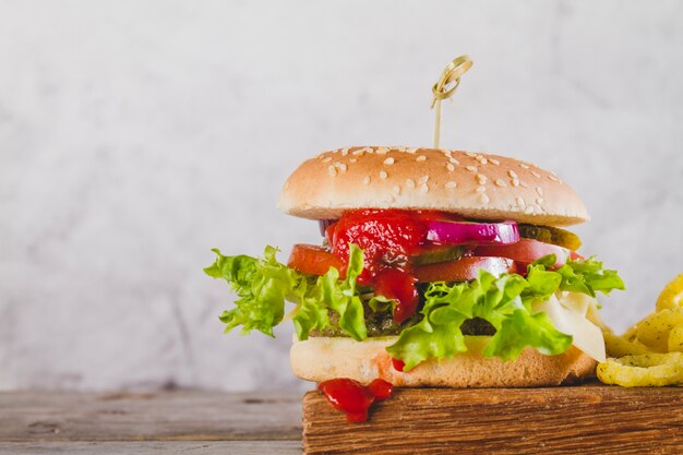 Tasty burger with lettuce and tomato