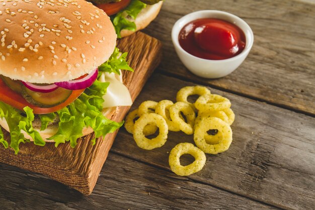 Tasty burger with pickles, lettuce and tomato