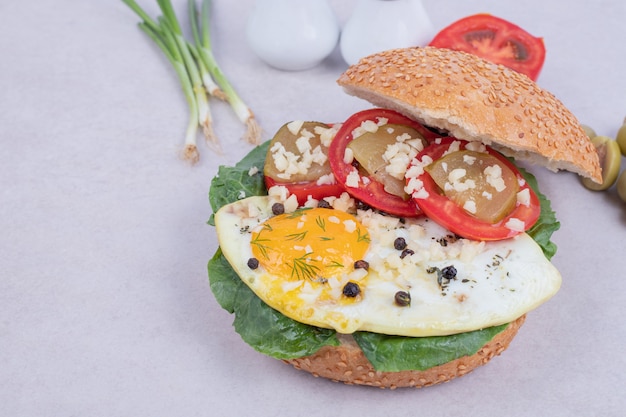 Tasty burger with tomato, cheese, lettuce on white.