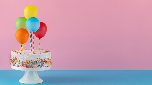 Tasty cake and colorful balloons