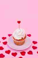 Free photo tasty cake with whip between decorative hearts