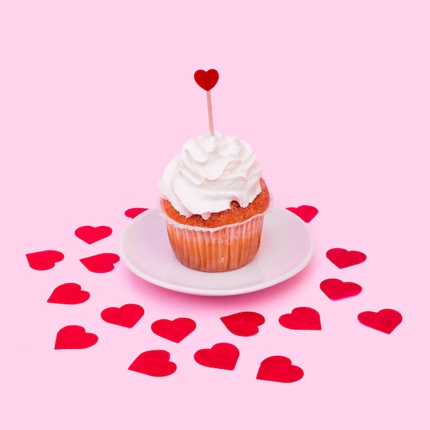 Free photo tasty cake with whip between ornament hearts