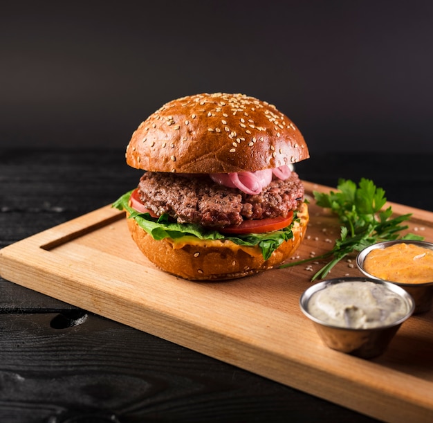 Tasty Cheeseburger on a Wooden Board – Free Stock Photo for Download