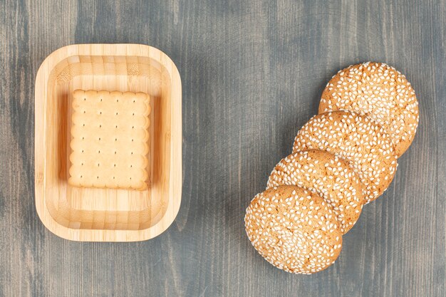 Tasty cookies with buns on a wooden table. High quality photo